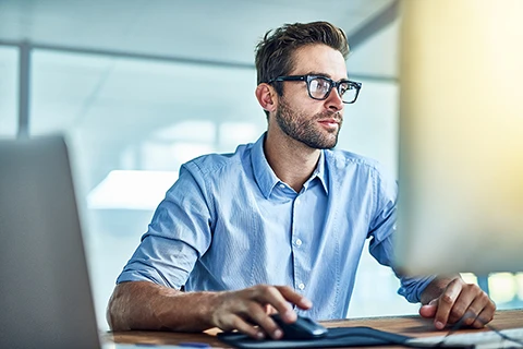 Man on a computer using Odessa's asset finance software to improve his customers' experience.